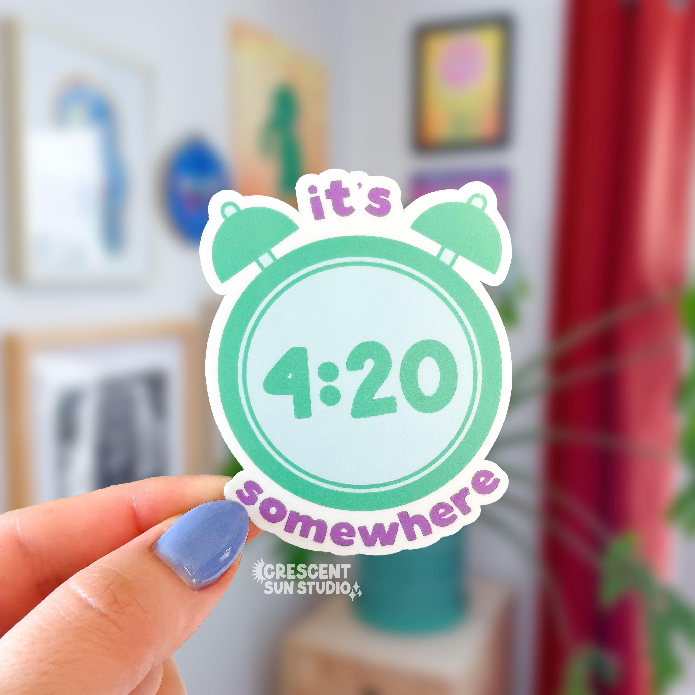 A die cut sticker of a mint green alarm clock with the time that reads 4:20