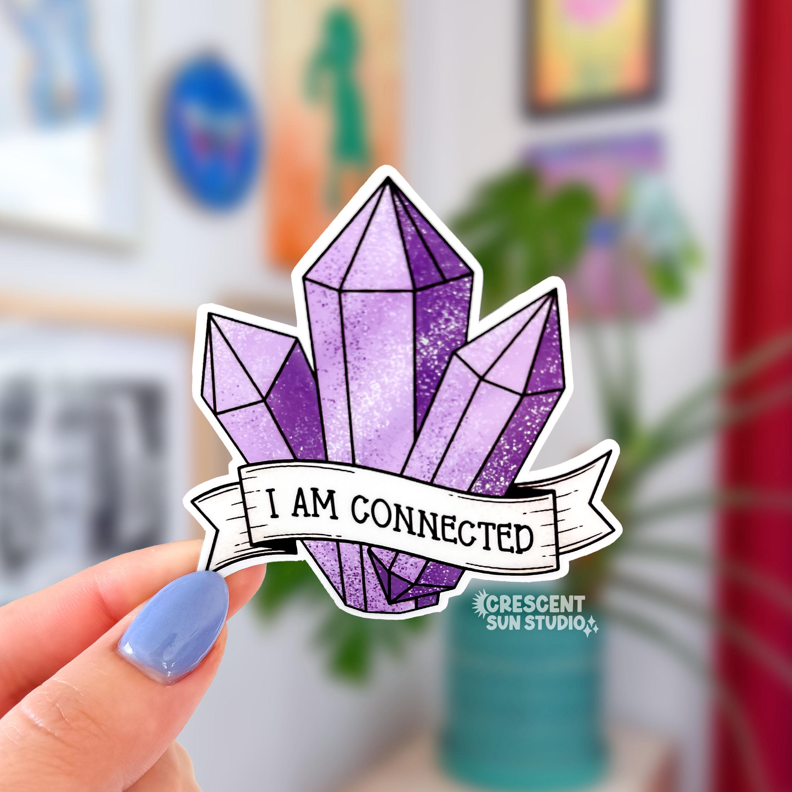 A sticker in the shape of three purple shaded crystals. At the bottom is a white banner with black text that reads "I am connected."