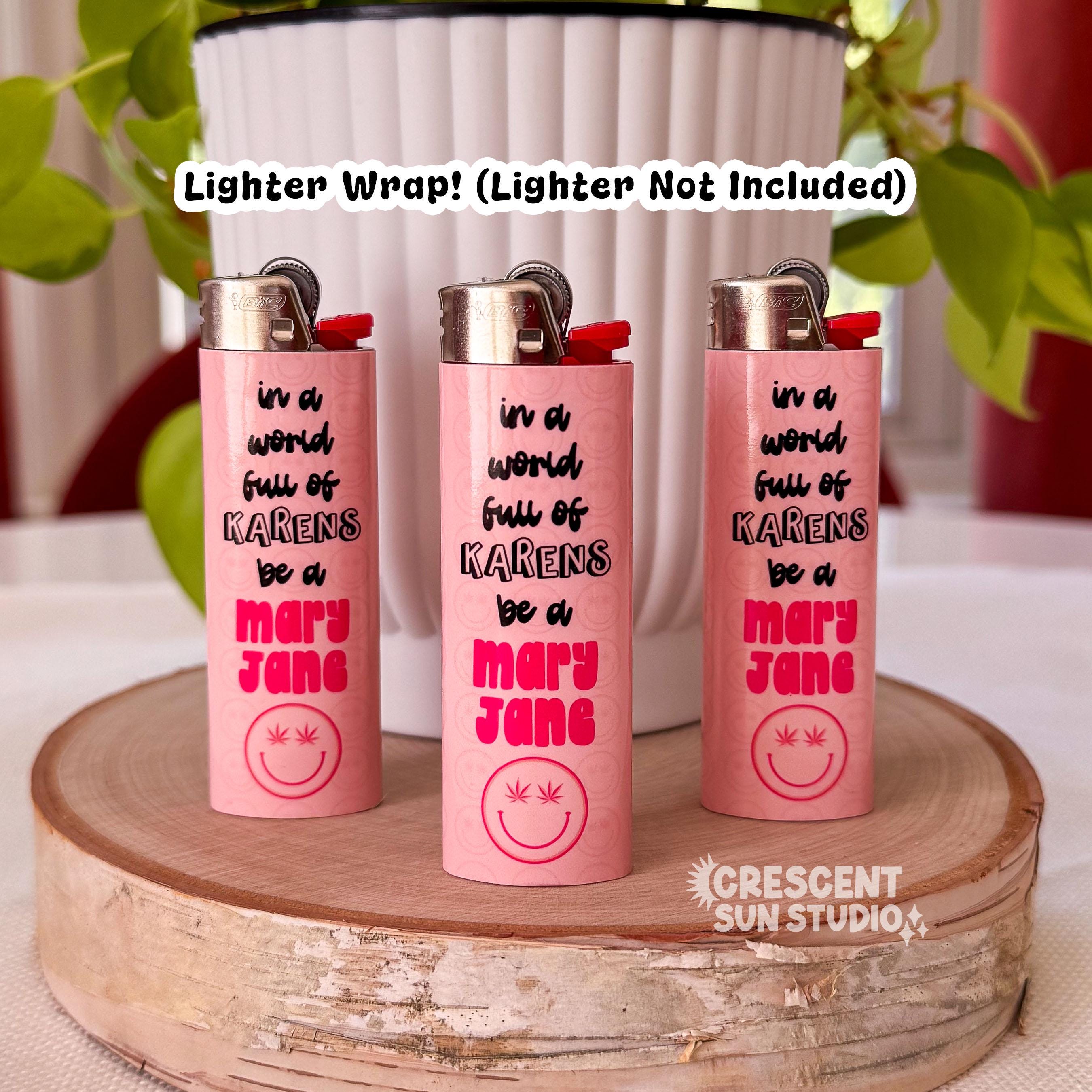 Three lighters are wrapped in our pink lighter wrap that reads "in a world full of karens be a" in black lettering and then "mary jane" in pink letters.

Across the image, text reads "lighter wrap! Lighter not included"