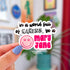 Die cut sticker with black text that reads, "in a world full of Karens, be a" and then there is a pink smiley face with cannabis leaves for eyes, and next to it in bold pink text it reads "mary jane."