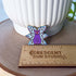 The pin sits above a wooden ruler, showing its width of 1.35 inches