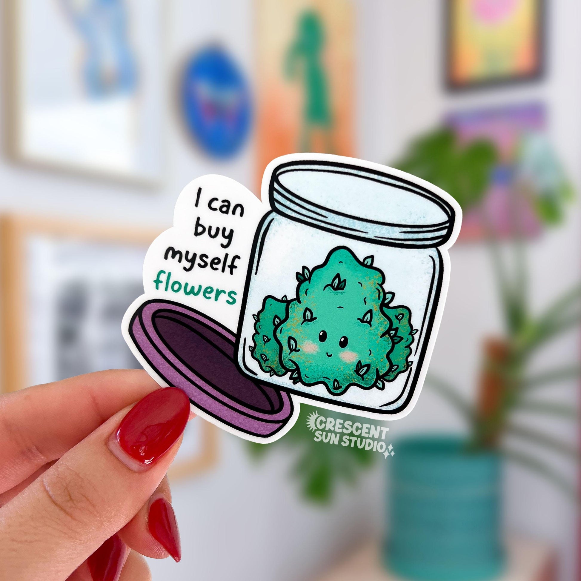 Die-cut sticker of a smiling cannabis nug in an open glass jar with a purple lid, with the text 'I can buy myself flowers' in black and teal lettering.