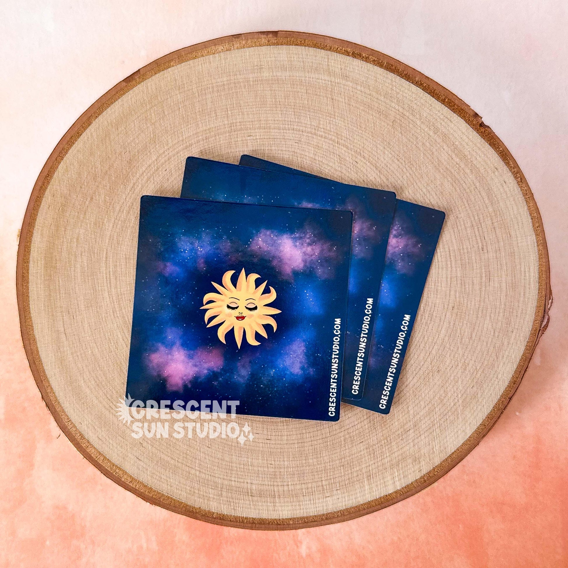 This lighter wrap features a blissed out and elevated glam sun floats in a purple-blue galaxy background. This personified sun has thin eyebrows, closed eyes with full lashes and eyeshadow, a nose ring, blushing cheeks, and glossy full lips.

In this image, the product is shown as it arrives to you, unwrapped from a lighter, as a square waiting to be applied.