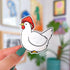 A die cut sticker of a white chicken wearing a red and white mushroom cap. 