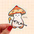 This cute sticker portrays a little orange capped mushroom character holding a dab tool with a glob of wax concentrate on it.