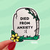 A light grey tombstone shaped sticker reads "died from anxiety :(" with a yellow flower in the bottom left corner.