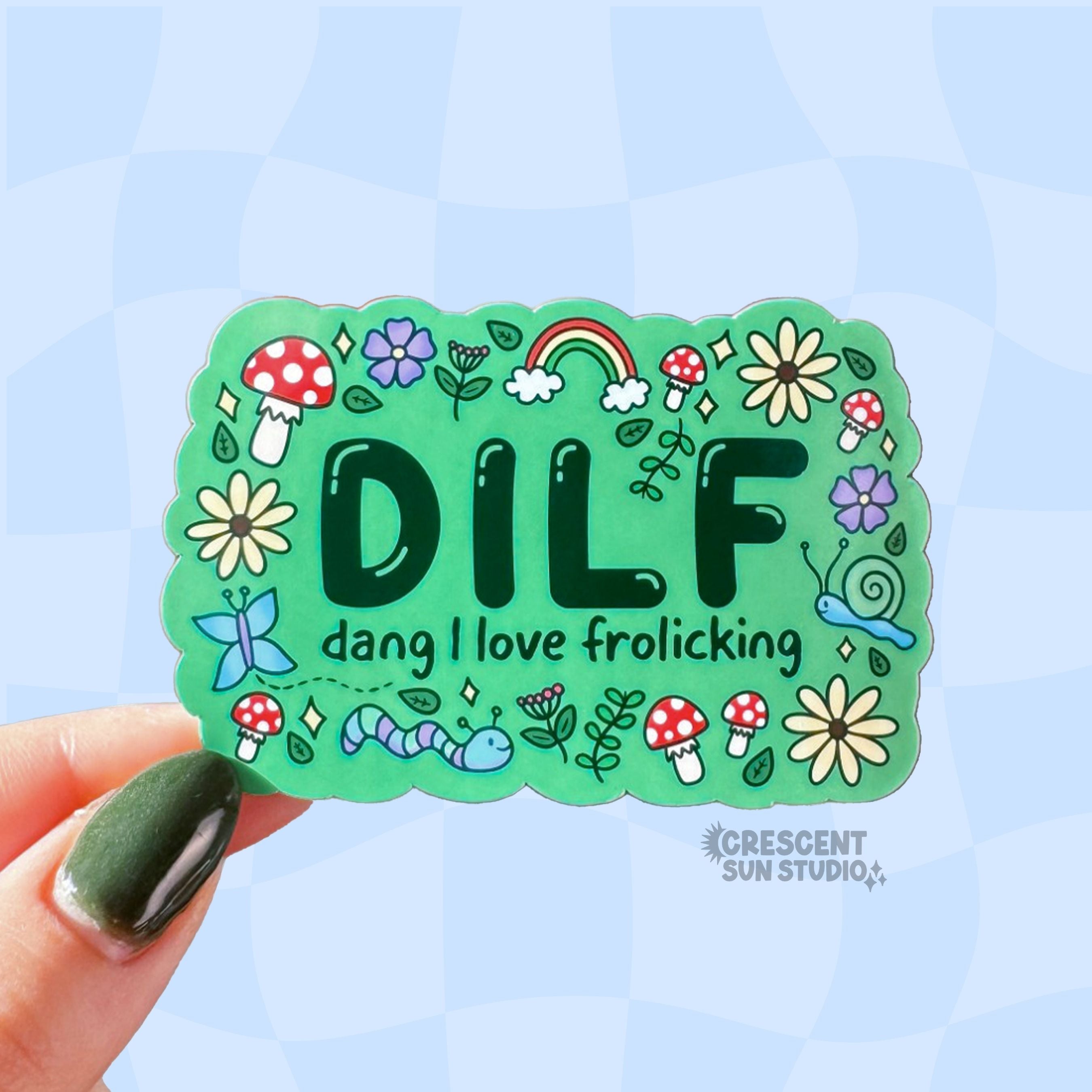 Colorful rectangle-shaped sticker with 'DILF man I love frolicking' text surrounded by doodles of mushrooms, critters, flowers and leaves.