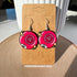 This bright pink pair of 8 ball inspired earrings say "dump him" in the center of the ball. There are also two sets of stars on either side of each ball and part of the letter 8 is visible at the bottom left of, as if curving around the side.