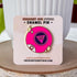 This bright pink 8 ball enamel pin says "dump him" in the center of the ball. There are also two sets of stars on either side of the pin and part of the letter 8 is visible at the bottom left of the pin, as if curving around the ball.

The pin, displayed on a card, leans against a white planter pot.