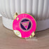 This bright pink fortune telling ball enamel pin says "dump him" in the center of the ball. There are also two sets of stars on either side of the pin and part of the letter 8 is visible at the bottom left of the pin, as if curving around the ball.

In this image, the pin leans against a large white plant pot.