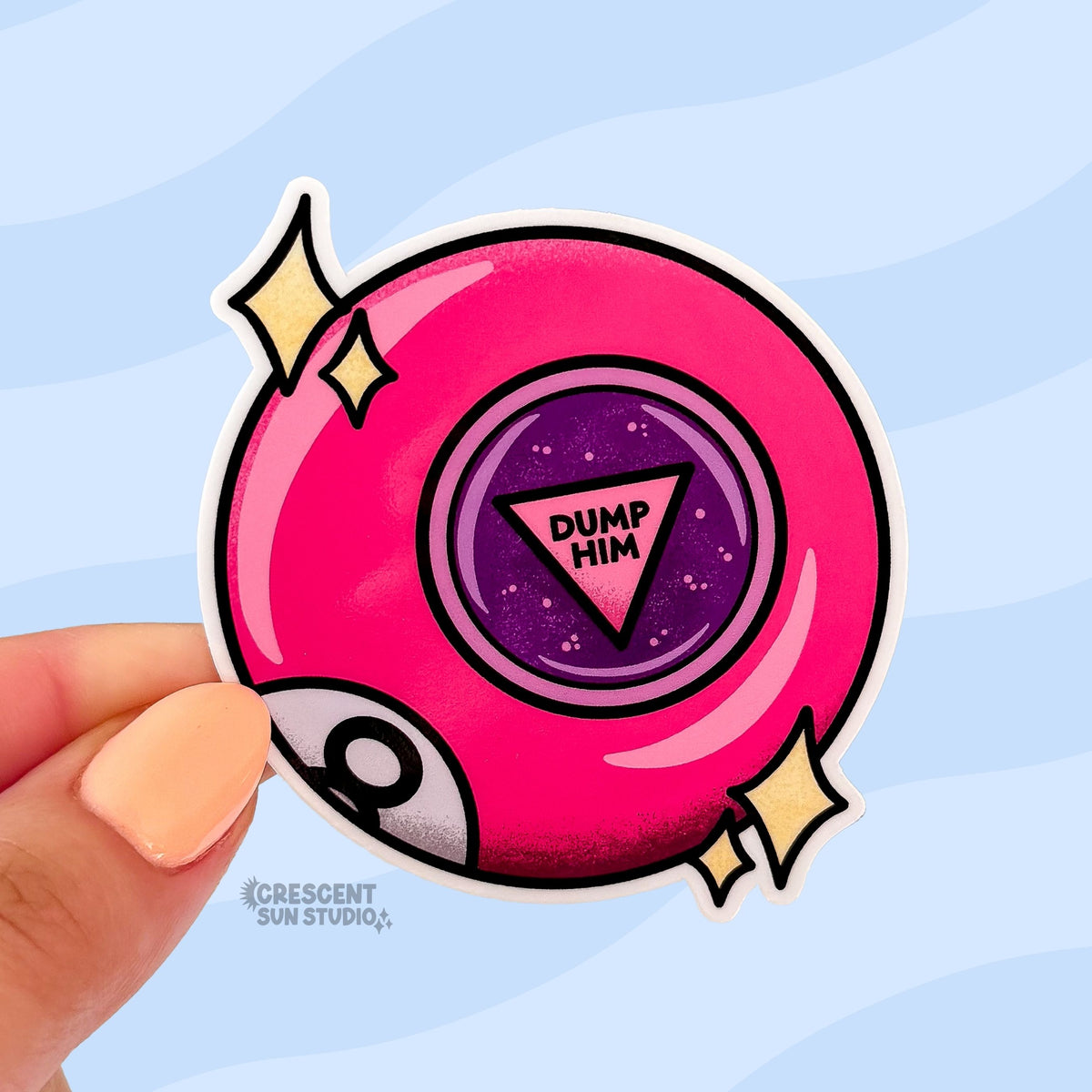 This bright pink 8 ball inspired sticker says "dump him" in the center of the ball. There are also two sets of stars on either side of the pin and part of the letter 8 is visible at the bottom left of the ball, as if curving around it.