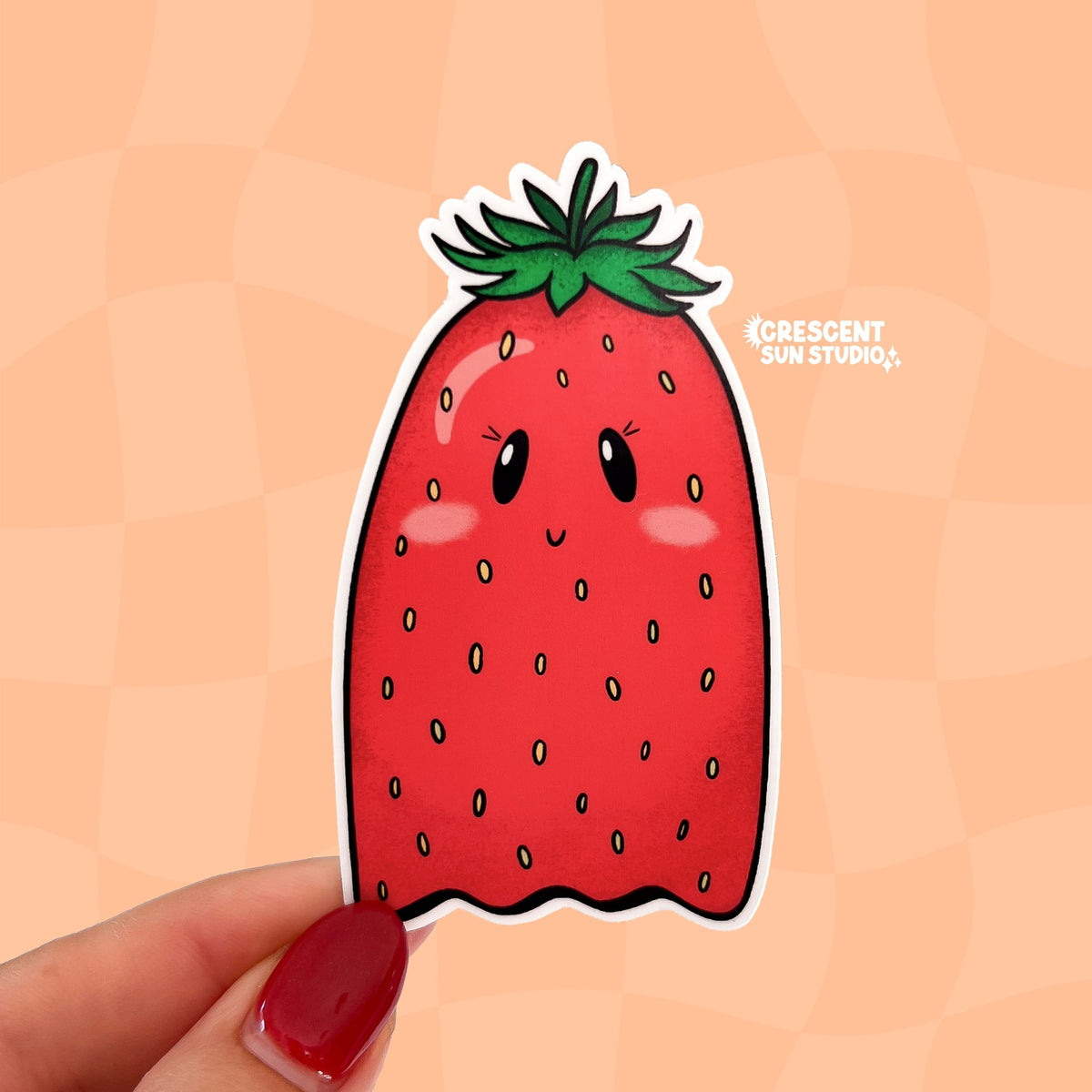 Die-cut sticker of a kawaii strawberry shaped like a ghost, with small eyes, pink cheeks, and a smile.