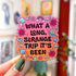 Die-cut sticker with a pink to orange gradient background reading 'What a Long Strange Trip It's Been' in black lettering surrounded by illustrated mushrooms, flowers with eyes, snails, a butterfly, and a worm.