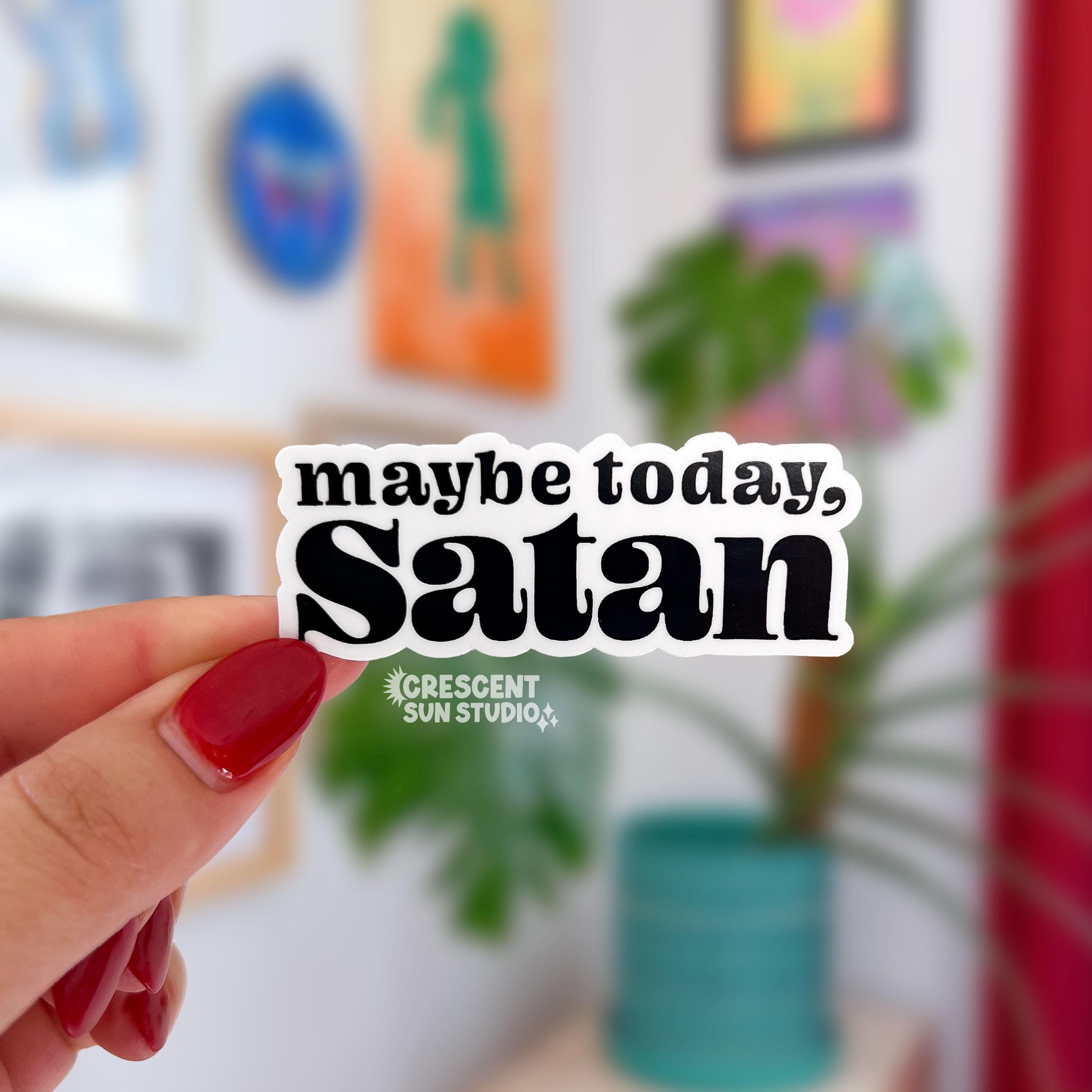 Hand holding a sticker that reads "maybe today, Satan"