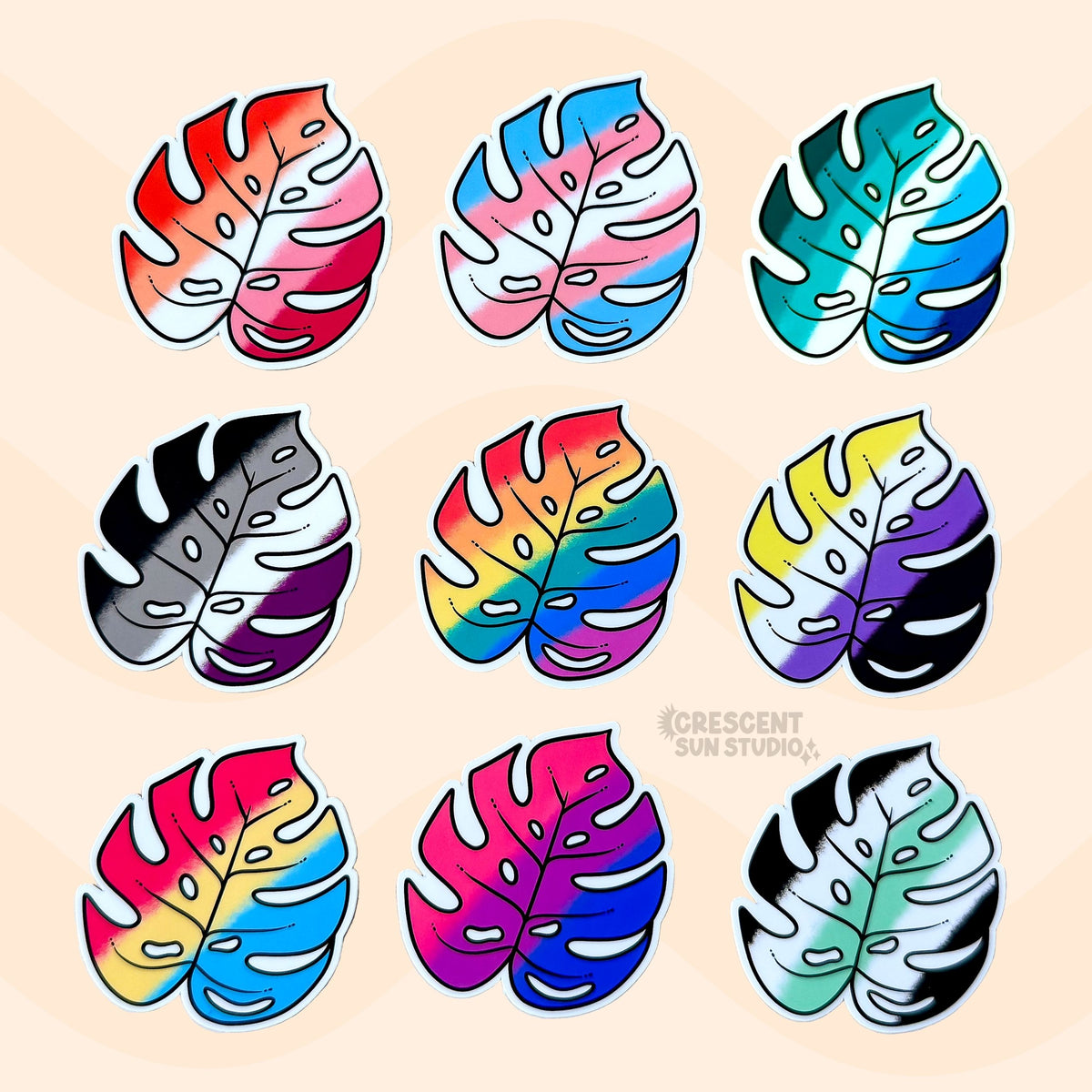Colorful monstera leaf stickers, each in the colors of different pride flags, are arranged in three rows of three.