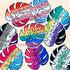 Colorful monstera leaf shaped stickers, each in the colors of different pride flags, are scattered on a beige surface.