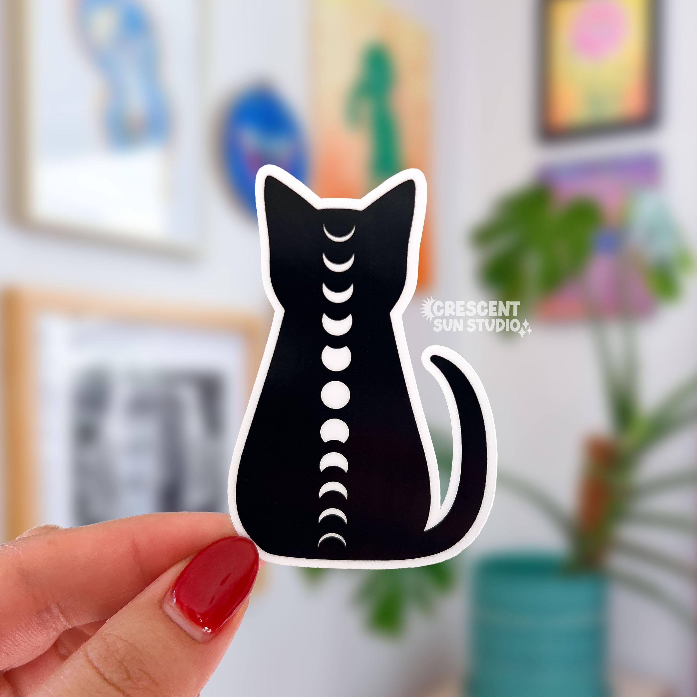 This sticker is of a black cat silhouette trimmed in white, with the full cycle of white moon phases running down its spine.