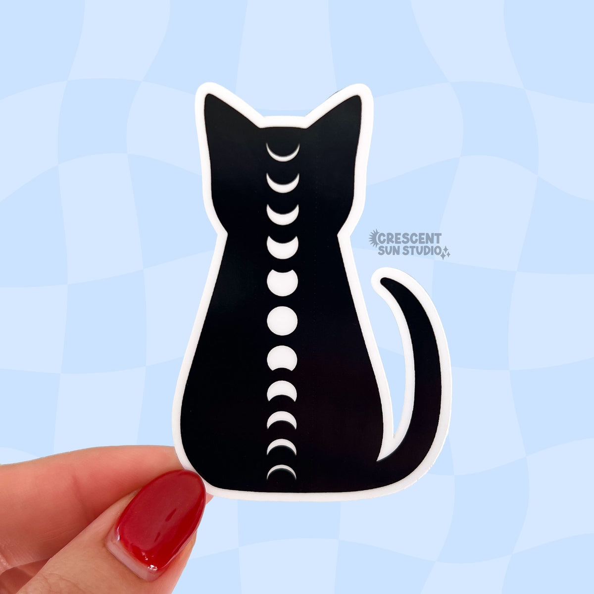 This sticker is of a black cat silhouette trimmed in white, with the full cycle of white moon phases running down its spine.