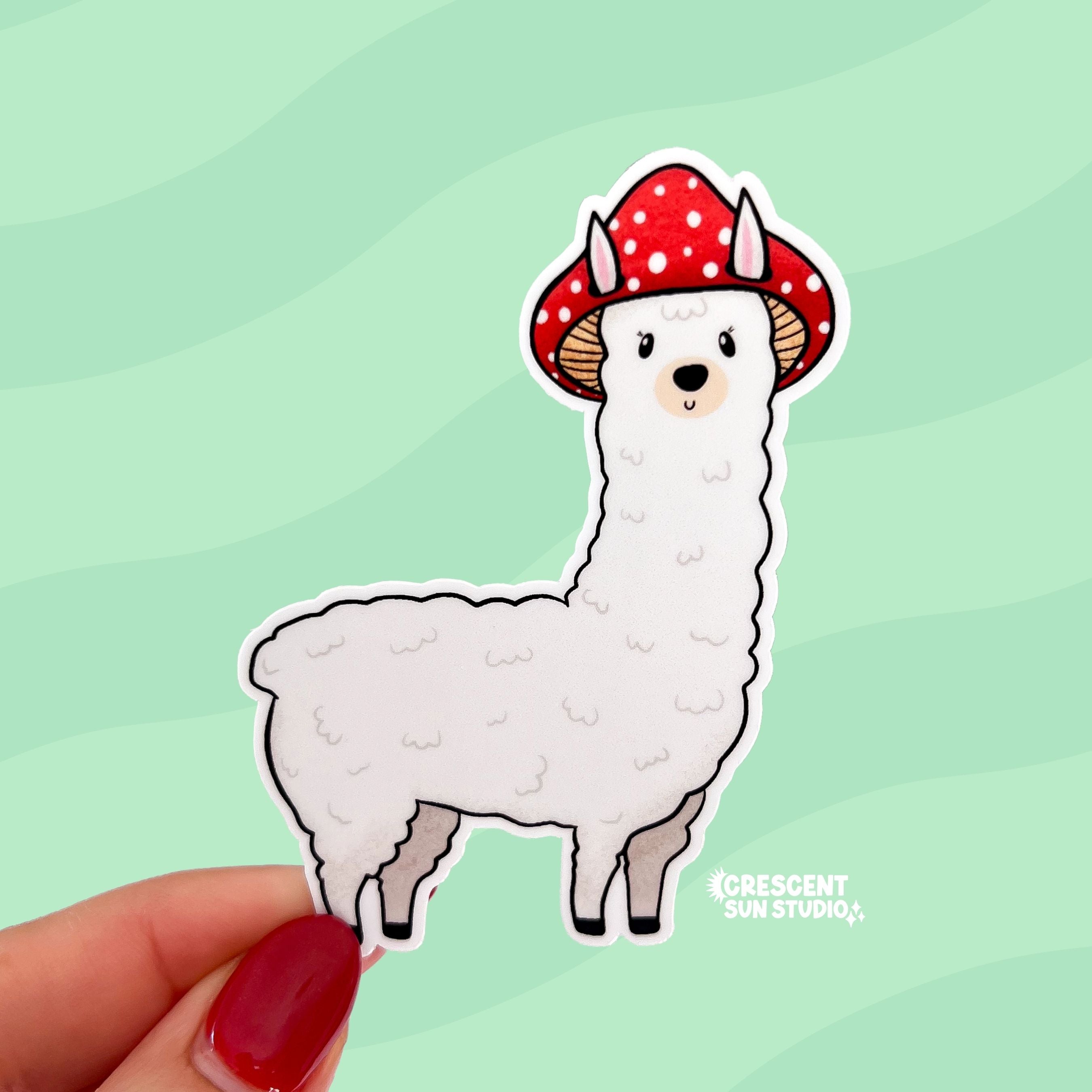A die cut sticker of a white alpaca wearing a red mushroom cap
