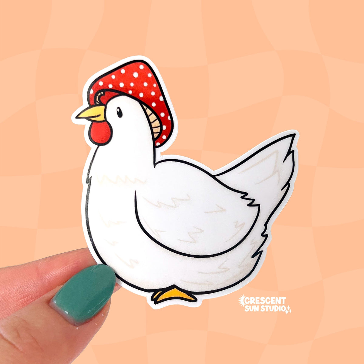 A die cut sticker of a white chicken wearing a red and white mushroom cap. 