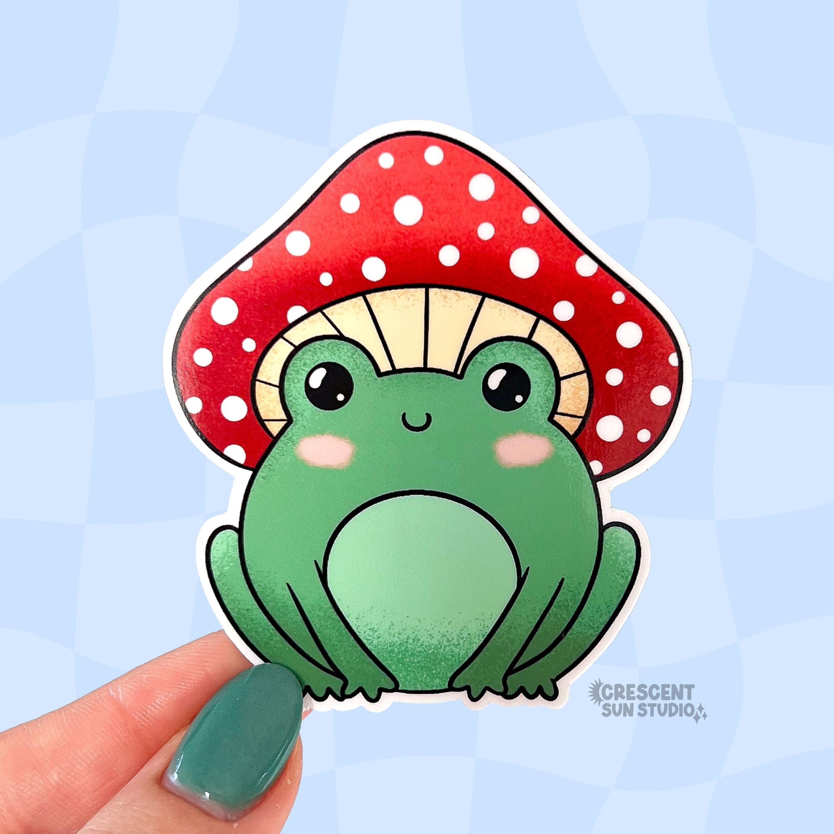 Sticker of a green frog with a red mushroom had