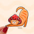 A sticker in the shape of a cat wearing a mushroom hat is held close to the camera. The cat is a tabby (orange with darker orange stripes) and has a sweet expression on his face. His red mushroom hat with white spots has spots for his ears to poke through. The cat is in a stretching pose with his tail curling up behind him.