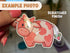 Image shows a pink cow sticker with a scratched finish.