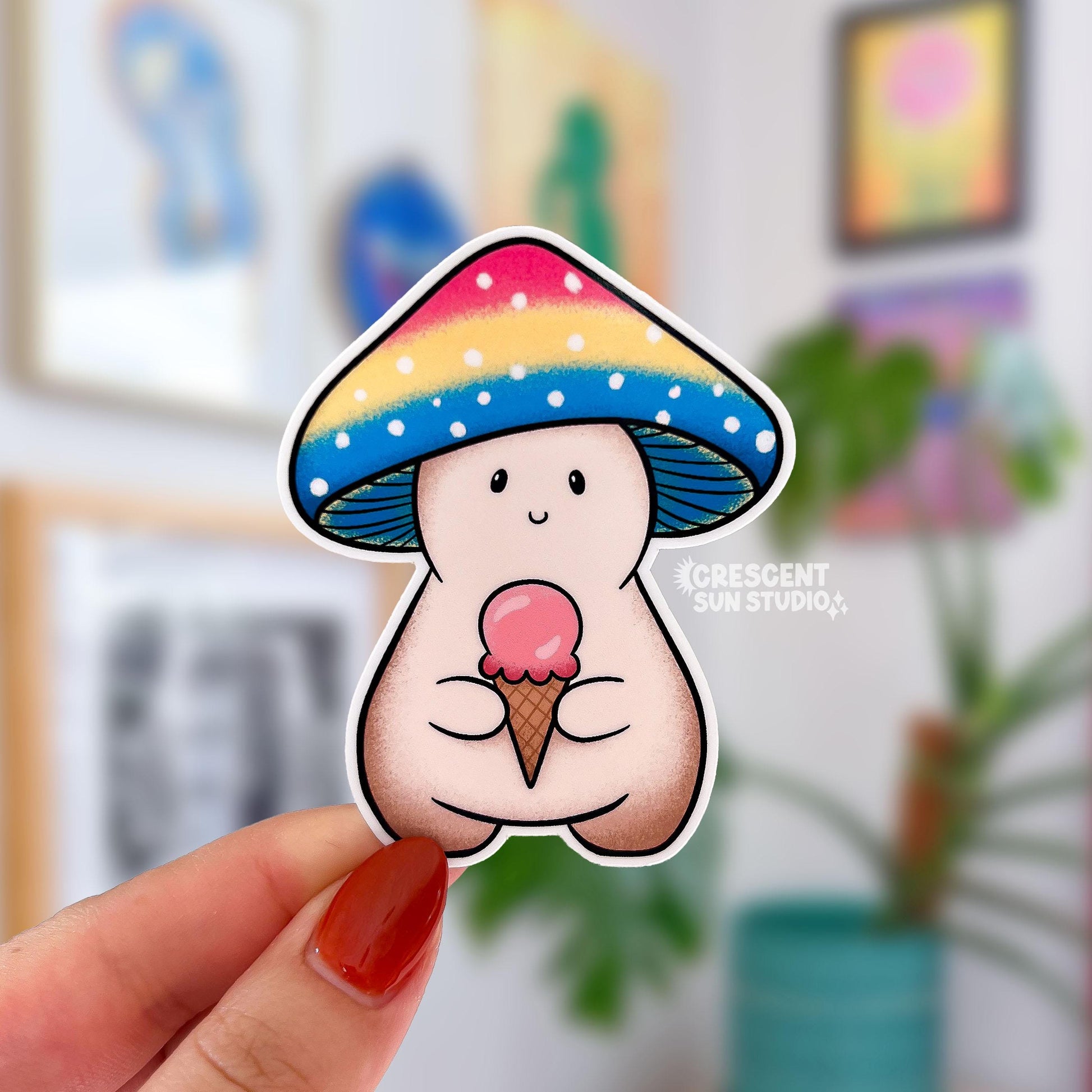 A mushroom character sticker whose cap is shaded pink, yellow, and blue. The mushroom is holding a pink ice cream cone.