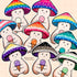 Colorful mushroom character stickers scattered on a beige surface. The caps of each mushroom depict the colors of different pride flags, and each mushroom character holds an ice cream cone with an ice cream scoop that matches a color on the mushroom caps.