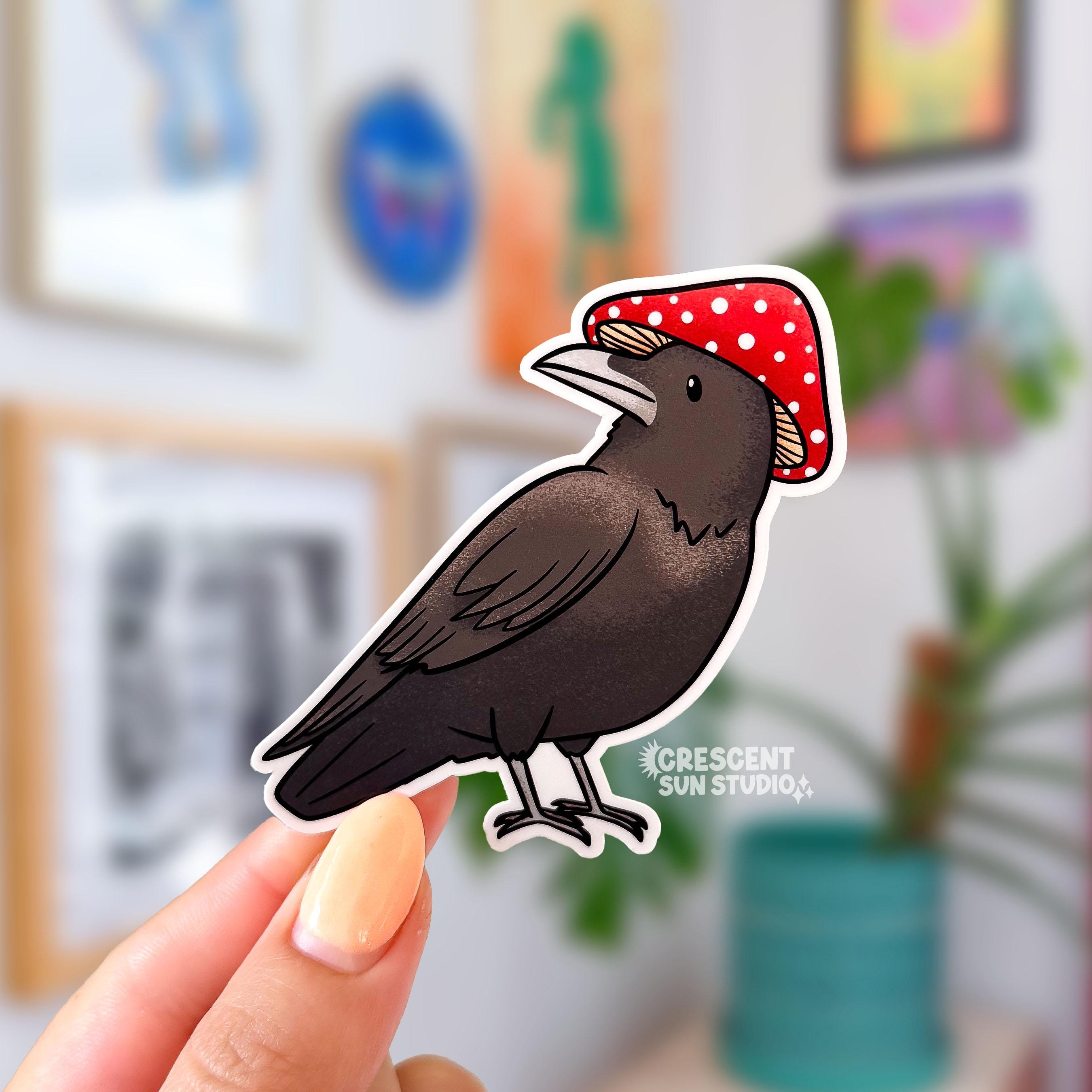 A sticker in the shape of a dark colored bird wearing a red and white mushroom for a hat.