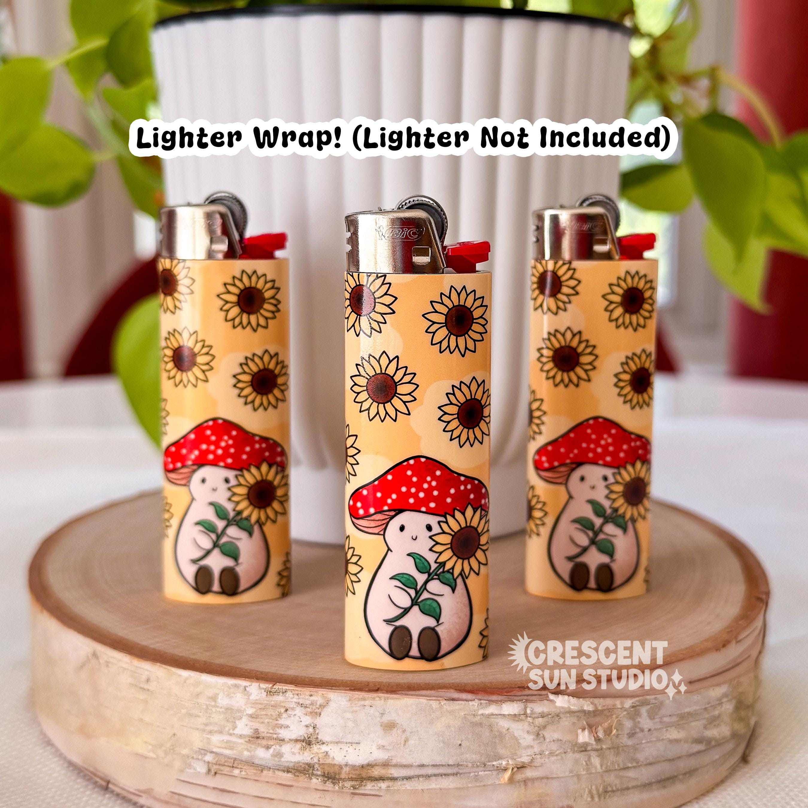 Three lighters each with  design of a warm yellow background dotted with brown and yellow sunflowers. In the foreground is an illustration of Stoney the Mushroom. He is a plump, smiling pinky-beige mushroom character with a red mushroom cap with white spots. Stoney is holding a large sunflower in his hands.

Across the top of this image is the text: "Lighter wrap! Lighter not included" in black lettering.