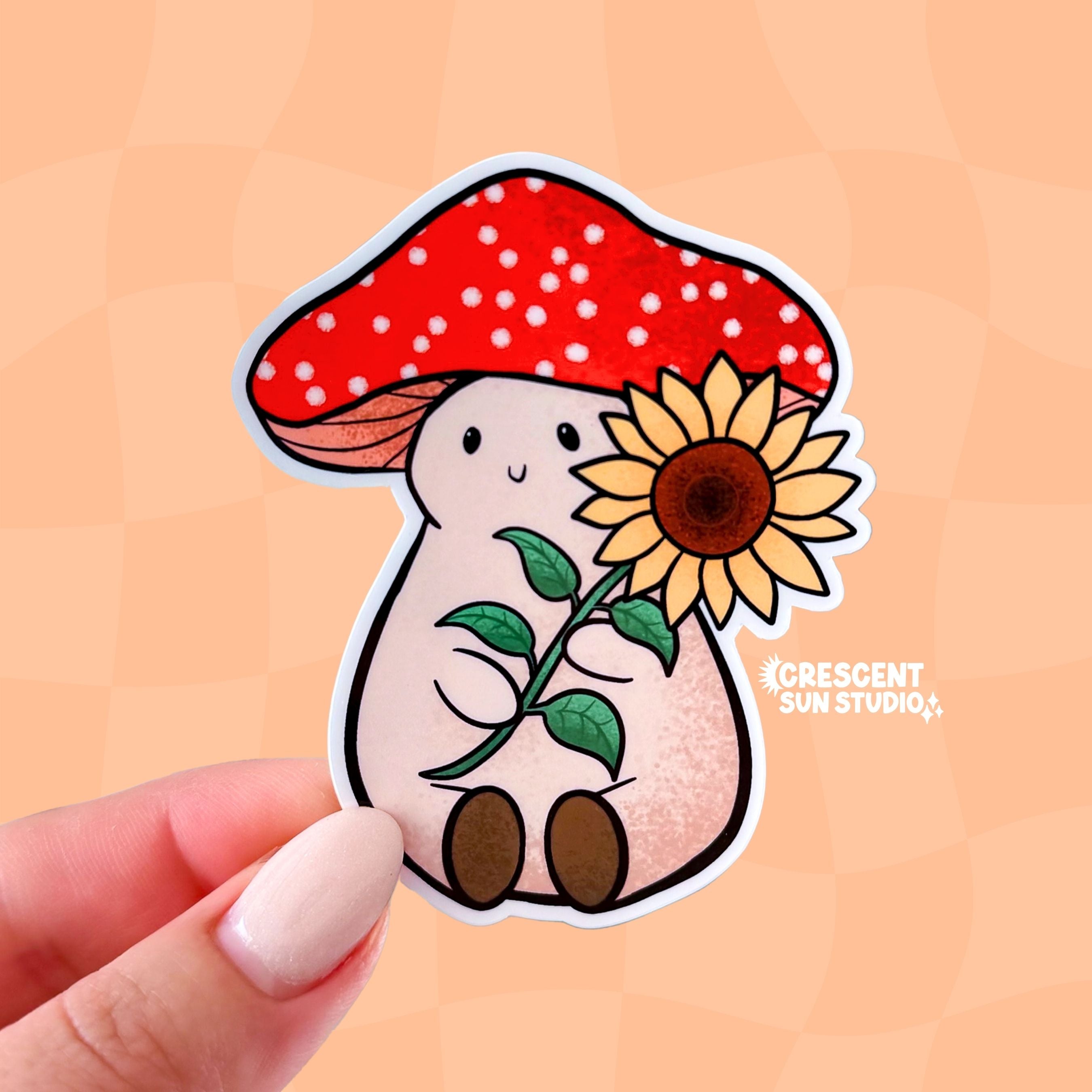 Stoney the Mushroom is a plump, smiling pinky-beige mushroom character with a red mushroom cap with white spots. Stoney is holding a large sunflower in his hands.