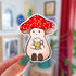 Stoney the Mushroom, a plump pinky-beige smiling mushroom character with a red spotted cap, is contentedly holding a frothy mug of beer in this vinyl sticker.