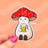 Stoney the Mushroom, a plump pinky-beige smiling mushroom character with a red spotted cap, is contentedly holding a frothy mug of beer in this vinyl sticker.
