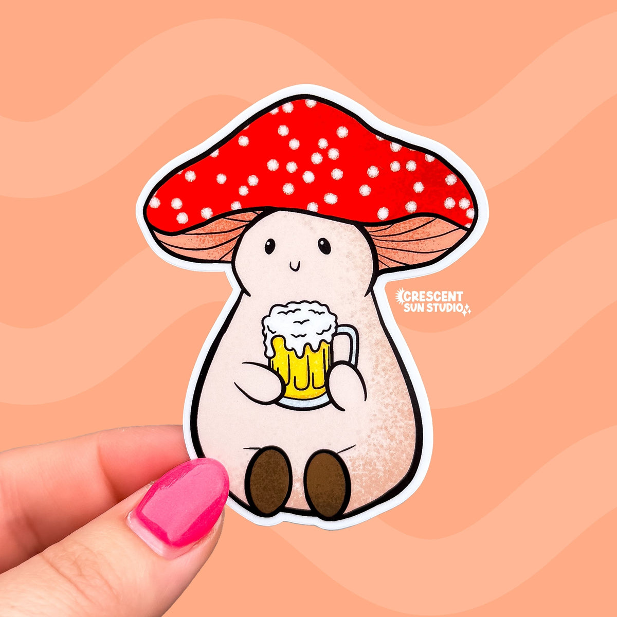 Stoney the Mushroom, a plump pinky-beige smiling mushroom character with a red spotted cap, is contentedly holding a frothy mug of beer in this vinyl sticker.