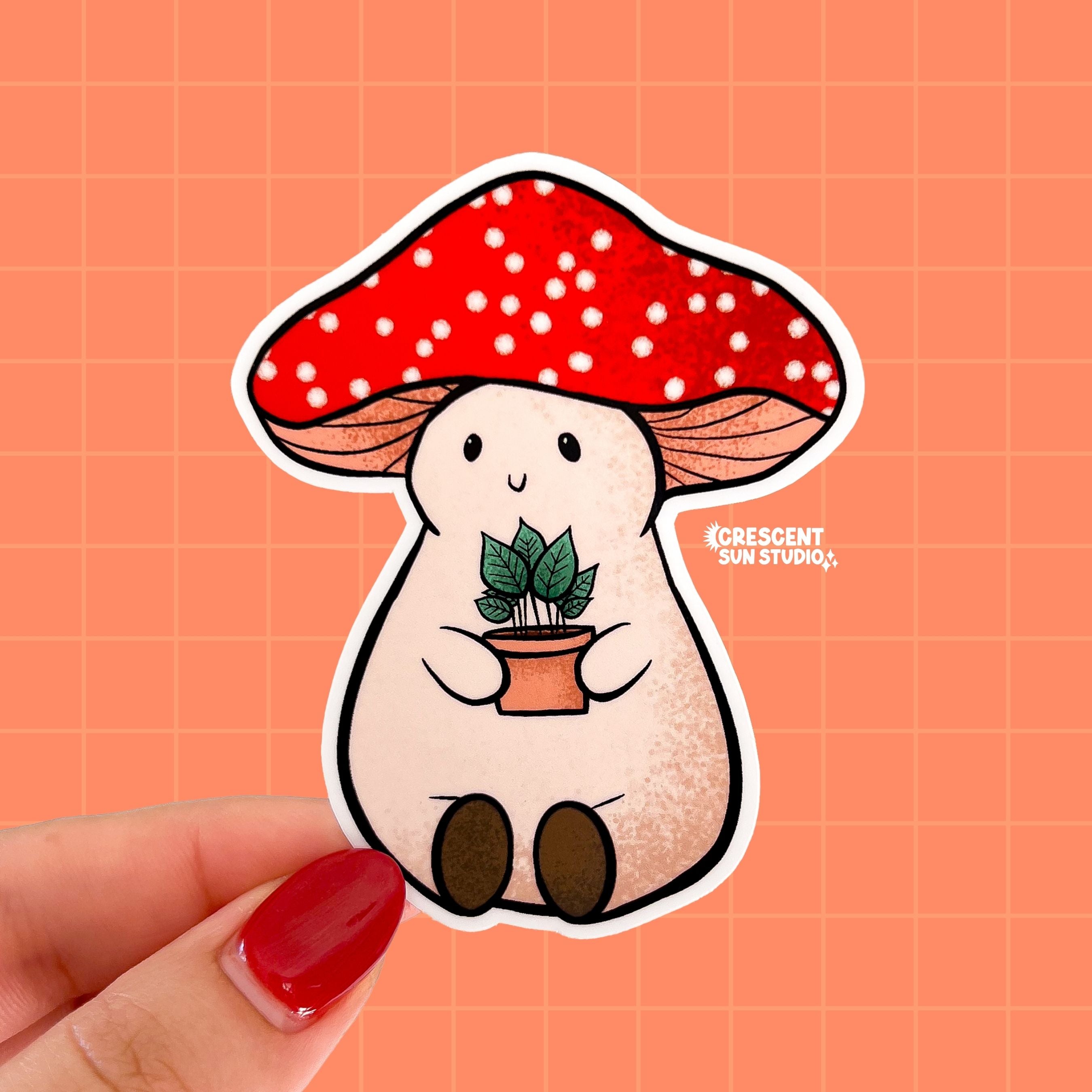 Stoney the Mushroom is a plump, smiling pinky-beige mushroom character with a red mushroom cap with white spots. Stoney is holding a tiny potted plant in his little mushroom arms. 