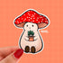 Stoney the Mushroom is a plump, smiling pinky-beige mushroom character with a red mushroom cap with white spots. Stoney is holding a tiny potted plant in his little mushroom arms. 