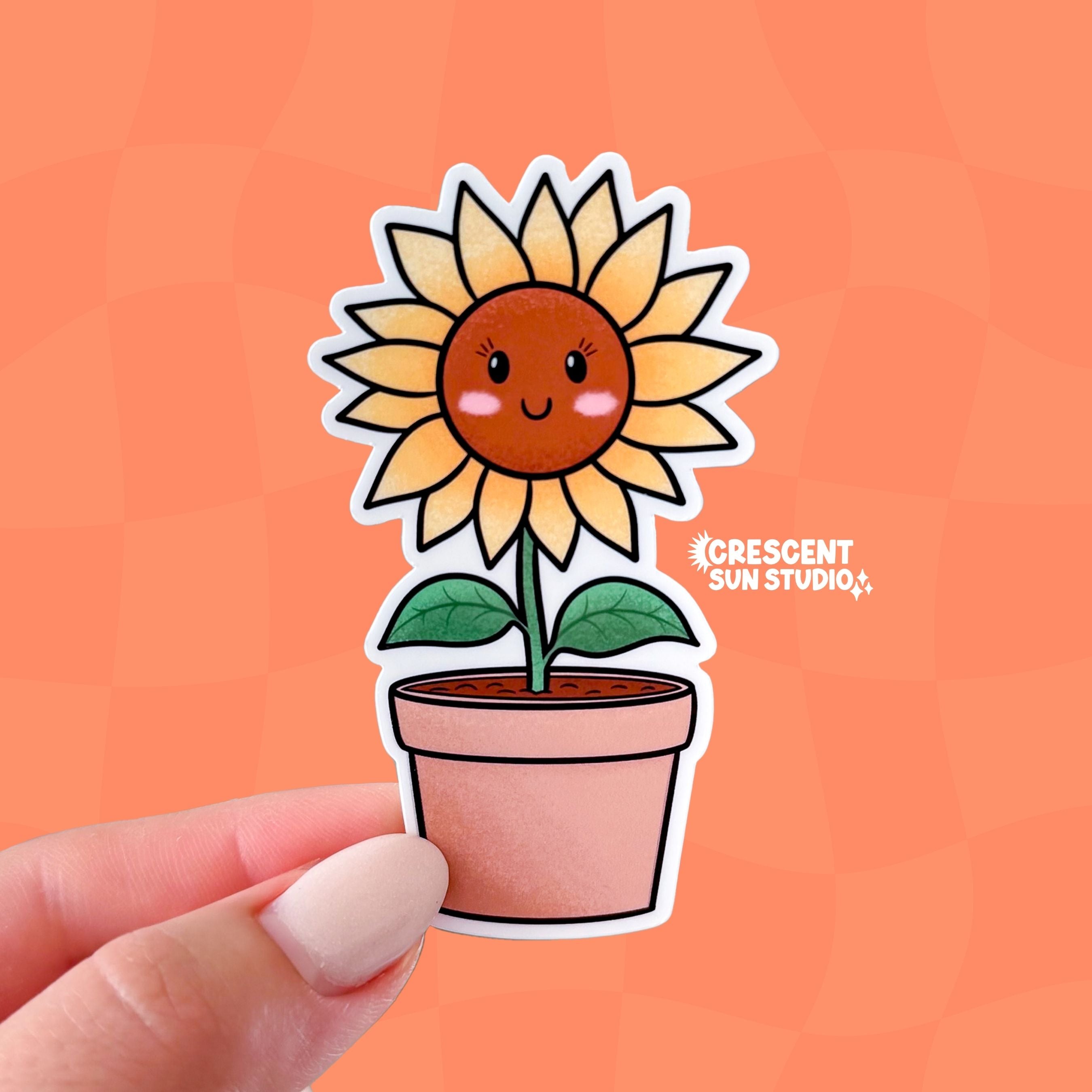 A smiling sunflower character with pink cheeks stands tall in a terracotta pot. The sunflower has yellow leaves and a warm brown face.
