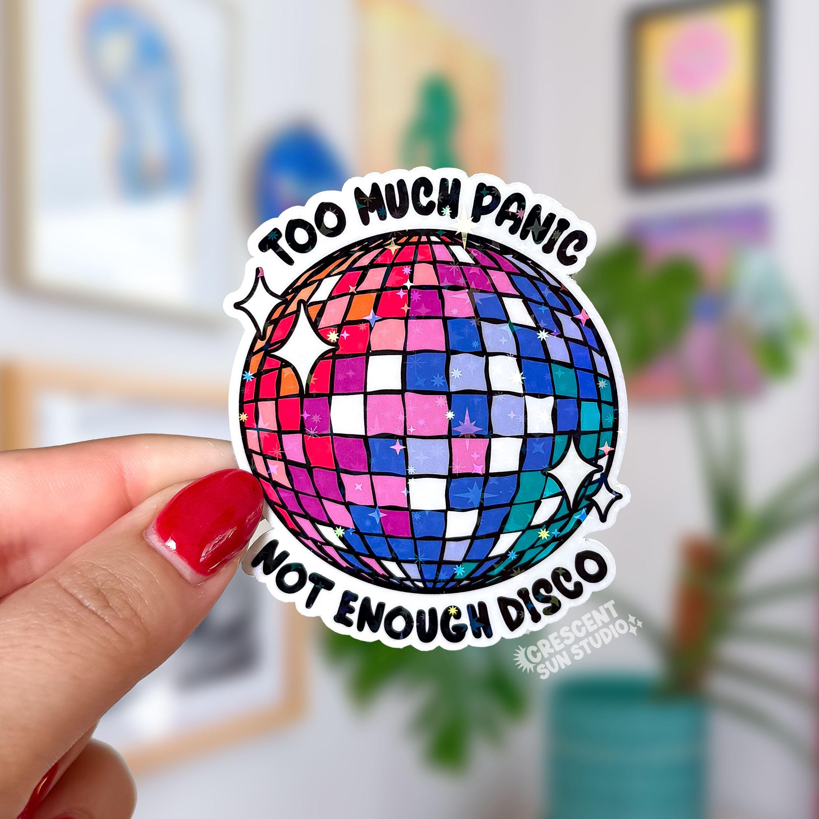 A colorful disco ball with the text "too much panic" on the top and "not enough disco" on the bottom.