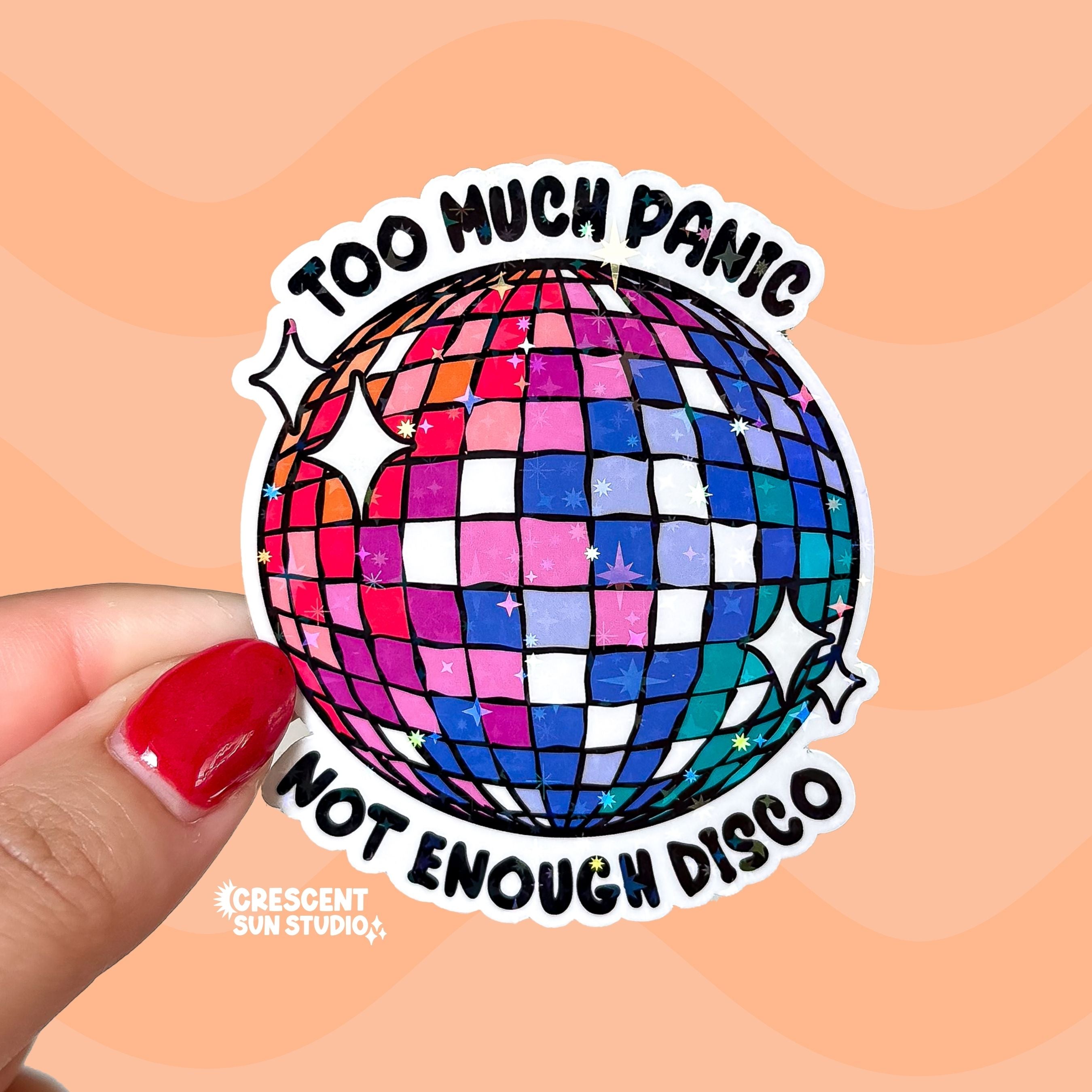 A colorful disco ball with the text "too much panic" on the top and "not enough disco" on the bottom.