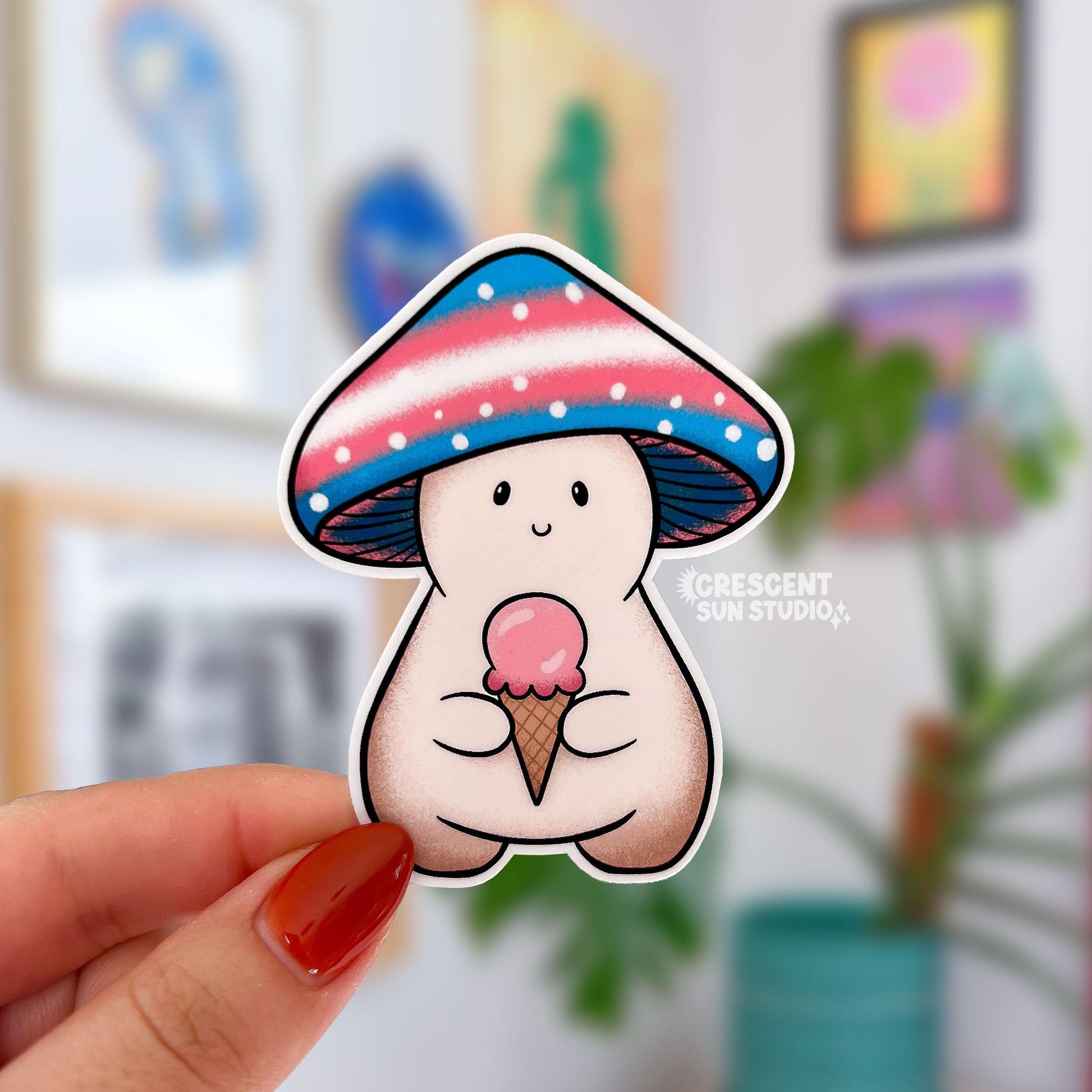 A mushroom character sticker whose cap is shaded blue, pink, and white. They are holding a pink ice cream cone.