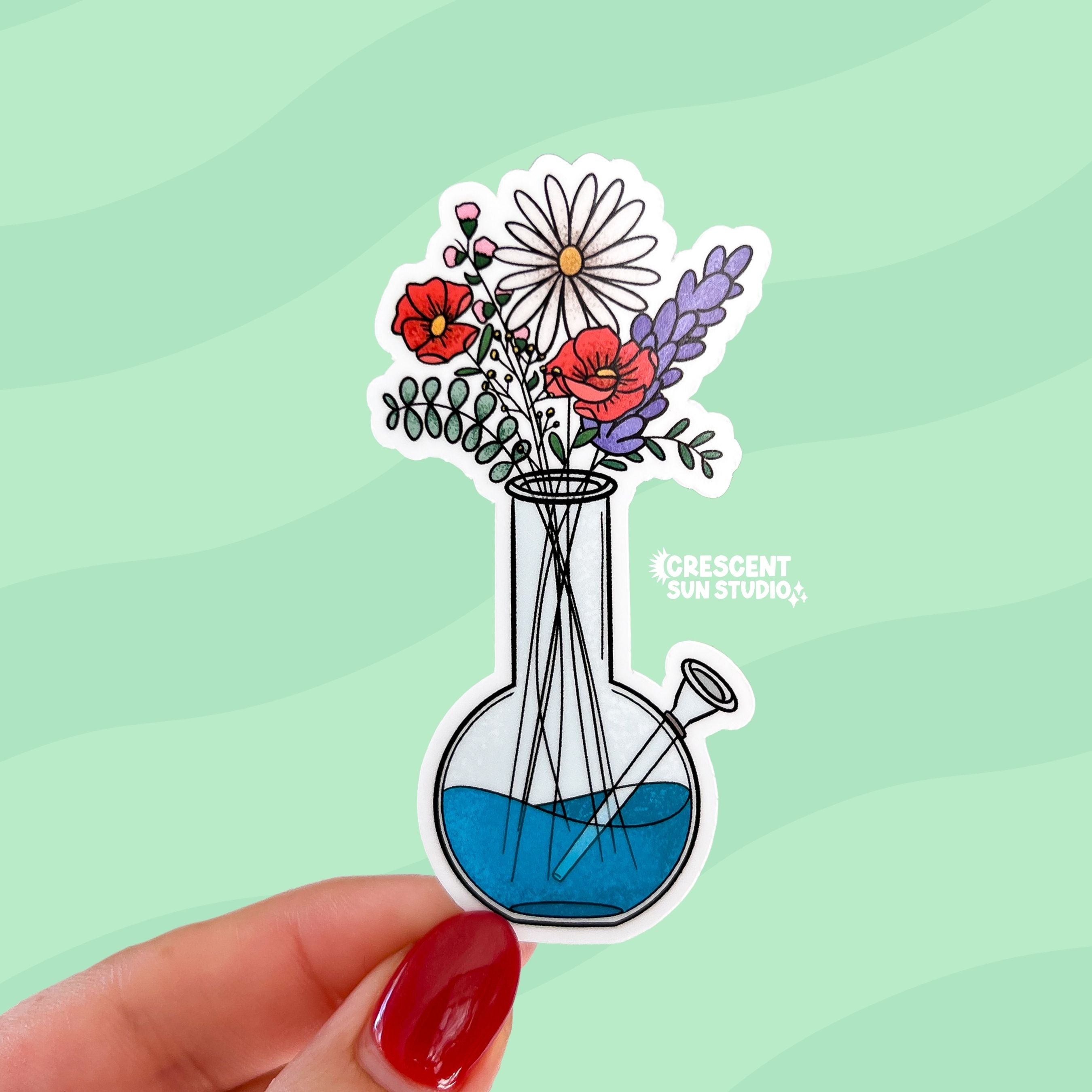 A die cut sticker of a bong with blue water being used as a vase for a variety of wildflowers