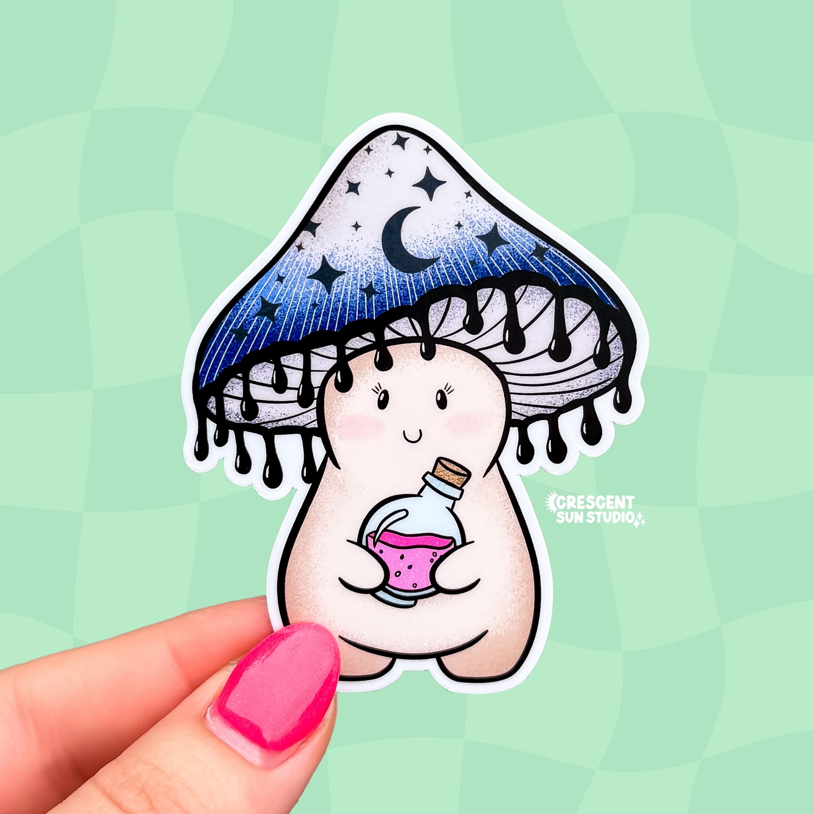 A sticker cut in the shape of a happy little mushroom character. Her mushroom cap is shaded blue-black with dark moons and stars on it. The bottom of the cap has little drips, resembling ink. She is holding a potion bottle with pink liquid inside.