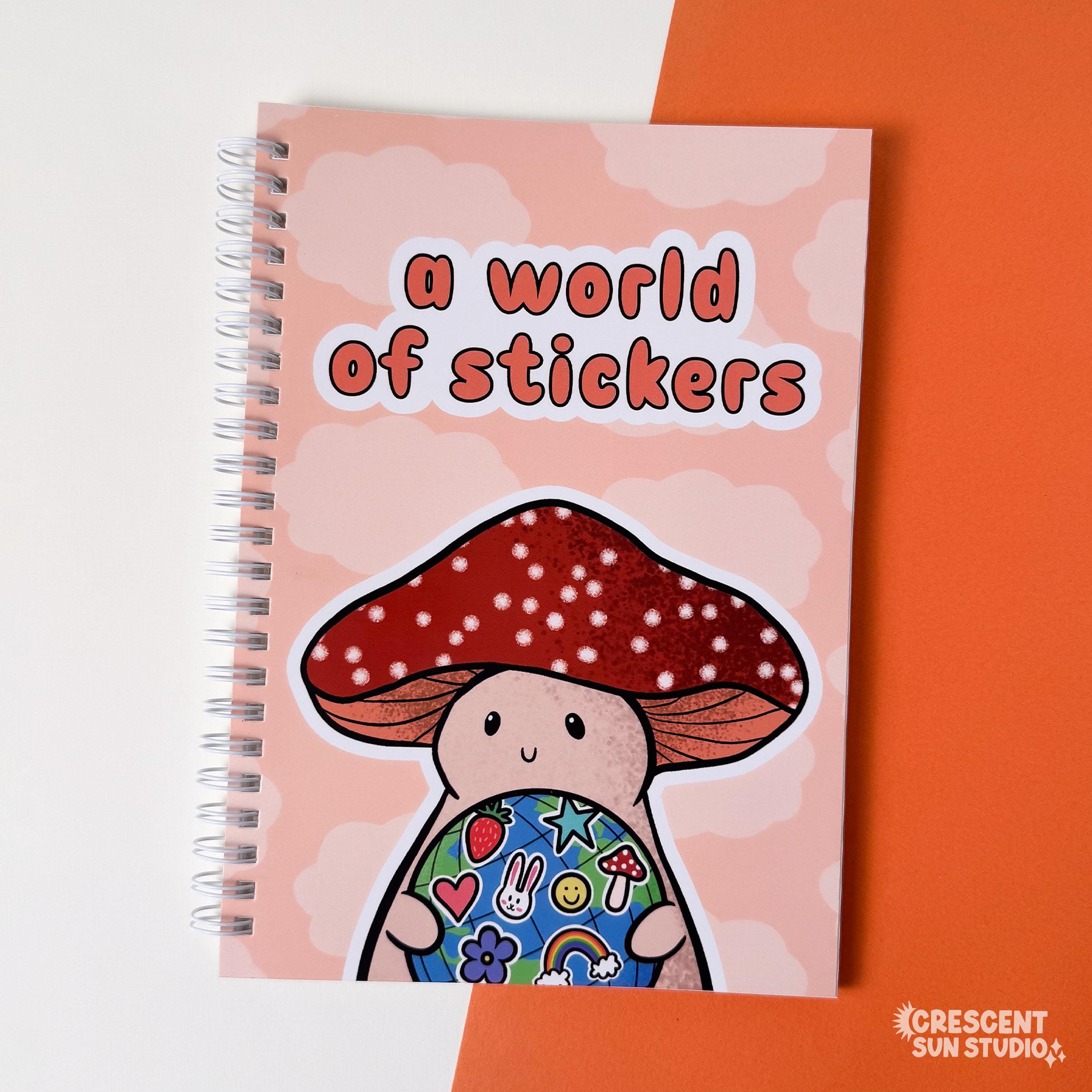 Spiral bound book with a background of peachy clouds. Coral text reads "a world of stickers." Below that is a happy mushroom holding a globe covered in stickers.